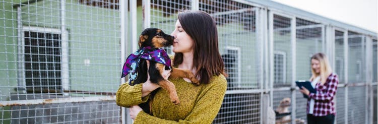 A woman smooches her rescue dog.