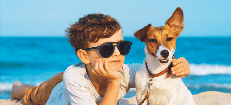 A dog and his best friend on the beach.