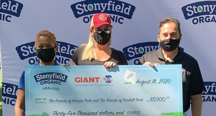 Philadelphia Councilwoman Cindy Bass accepts a check from Stonyfield Organic for organic parks and maintenance practices.