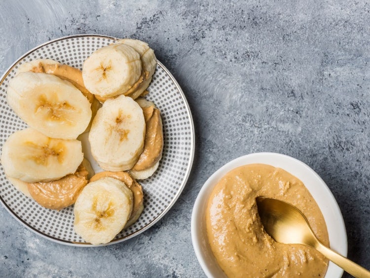 A plate of food and a bowl of peanut butter Description automatically generated