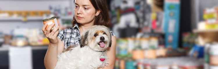 A person holding a dog AI-generated content may be incorrect.