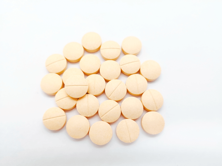 A pile of pale-orange acetylcysteine pills for dogs and cats.