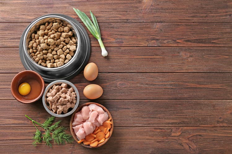 A selection of food spread out across a brown, wooden floor.