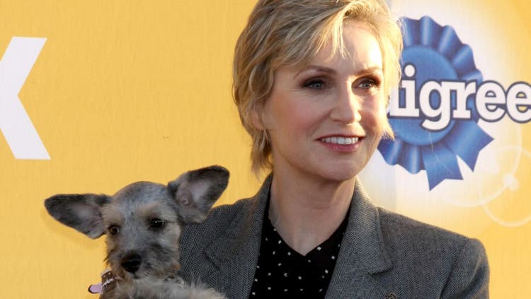 Actress and comedian Jane Lynch poses with her dog.