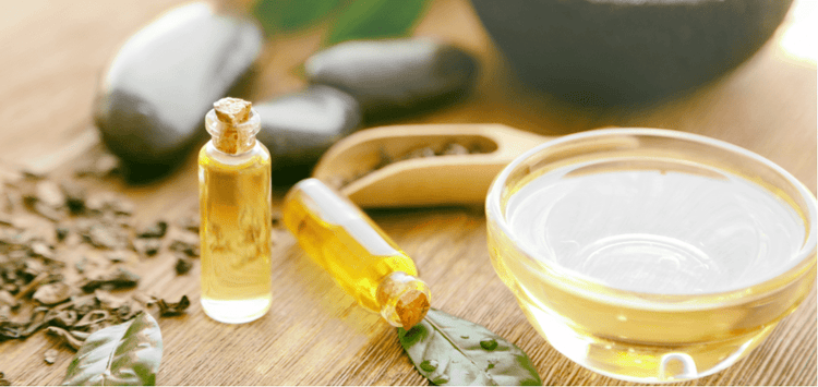 Tea tree oil in a bowl and jar.