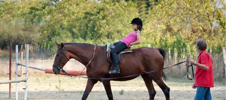 A girl received equine-assisted therapy.