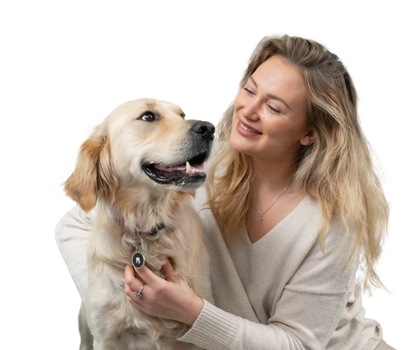 Warm embrace between a golden retriever and a person in a cozy sweater